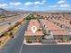 A beautiful aerial view of a modern home and neighborhood in a serene setting under a blue sky at 2596 Lazy Saddle Dr, Henderson, NV 89002