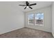 Neutral bedroom featuring carpeted floors, dual pane windows and a ceiling fan at 2596 Lazy Saddle Dr, Henderson, NV 89002
