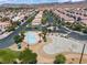 Aerial view showcases a pool and lush landscaping with a backdrop of desert mountains at 2596 Lazy Saddle Dr, Henderson, NV 89002
