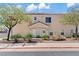 Charming home featuring a cozy entrance, desert landscaping, and mature trees at 2596 Lazy Saddle Dr, Henderson, NV 89002