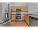 Well-lit kitchen with stainless steel appliances, wooden cabinets and a double basin sink at 2596 Lazy Saddle Dr, Henderson, NV 89002