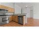 Open kitchen with stainless steel appliances, wooden cabinets, and an island eating counter at 2596 Lazy Saddle Dr, Henderson, NV 89002