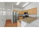 Well-lit kitchen boasts stainless steel appliances, granite counters, and plenty of cabinet space at 2596 Lazy Saddle Dr, Henderson, NV 89002
