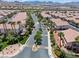 Aerial view showcasing a well-planned community with lush landscaping and palm-lined streets at 2596 Lazy Saddle Dr, Henderson, NV 89002