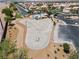 Community skate park featuring a smooth concrete surface, bordered by landscaping, and a nearby pool at 2596 Lazy Saddle Dr, Henderson, NV 89002