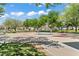 Colorful splash pad with rainbow sprinkler feature, benches, and picnic areas surrounded by green space at 2596 Lazy Saddle Dr, Henderson, NV 89002