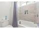 A tiled tub shower with a built-in niche sits next to a low-flow toilet at 295 Callen Falls Ave # 2225, Henderson, NV 89011