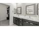 Bathroom showcasing a dual sink vanity with modern fixtures and a walk-in closet at 295 Callen Falls Ave # 2225, Henderson, NV 89011