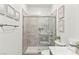 Modern glass shower with gray tile surround, handheld sprayer and toilet with a white counter at 295 Callen Falls Ave # 2225, Henderson, NV 89011