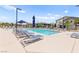 Inviting community pool area with lounge chairs, umbrellas, and well-maintained surroundings at 295 Callen Falls Ave # 2225, Henderson, NV 89011