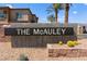 The McAuley community sign with desert landscaping and palm trees offers a welcoming entrance to the neighborhood at 295 Callen Falls Ave # 2225, Henderson, NV 89011