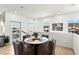 Cozy dining area featuring a round table, seating for four, and views of the neighborhood through the windows at 295 Callen Falls Ave # 2225, Henderson, NV 89011