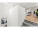 Open hallway leading to the kitchen featuring hardwood floors and staircase access at 295 Callen Falls Ave # 2225, Henderson, NV 89011