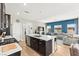 The kitchen island offers bar seating and a sink, with light countertops, and a stylish design for a modern living experience at 295 Callen Falls Ave # 2225, Henderson, NV 89011