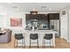 This kitchen provides a large island with counter seating, stainless appliances, and a modern design at 295 Callen Falls Ave # 2225, Henderson, NV 89011