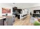 An open-concept kitchen offers dark cabinetry, stainless appliances, a dining area and an island with counter seating at 295 Callen Falls Ave # 2225, Henderson, NV 89011