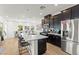 Bright kitchen featuring stainless appliances, a large island with seating, and modern design for culinary enthusiasts at 295 Callen Falls Ave # 2225, Henderson, NV 89011