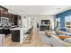 A bright living room is open to the kitchen and boasts a wall mounted fireplace, views, and modern furnishings at 295 Callen Falls Ave # 2225, Henderson, NV 89011