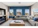 Relax in the well-lit living room with a comfy sofa, a modern fireplace and neighborhood views through large windows at 295 Callen Falls Ave # 2225, Henderson, NV 89011