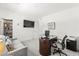 Office area with sofa, desk, chair, and TV, plus a closet with shelving for storage at 295 Callen Falls Ave # 2225, Henderson, NV 89011