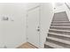 Interior stairway featuring carpeted steps, fresh white walls, and a secured door at 295 Callen Falls Ave # 2225, Henderson, NV 89011