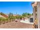 Spacious backyard with gravel landscaping, patio area, flowering plants, and privacy fencing, offering a serene outdoor space at 3028 Treesdale Dr, Las Vegas, NV 89134