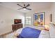 Well-lit bedroom featuring a ceiling fan, mounted TV, and view to the outside at 3028 Treesdale Dr, Las Vegas, NV 89134