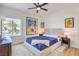 Stylishly decorated bedroom with a large window, ceiling fan, and Disney art at 3028 Treesdale Dr, Las Vegas, NV 89134
