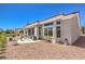 Charming home exterior with covered patio, gravel landscaping, and well-maintained surroundings, blending style and comfort at 3028 Treesdale Dr, Las Vegas, NV 89134