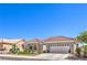 Charming one-story home with a tile roof, spacious three-car garage, and low-maintenance desert landscaping at 3028 Treesdale Dr, Las Vegas, NV 89134
