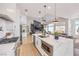 Modern kitchen with stainless steel appliances, a waterfall island, and an open floor plan at 3028 Treesdale Dr, Las Vegas, NV 89134