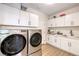 Functional laundry room with a washer, dryer, and ample cabinet space at 3028 Treesdale Dr, Las Vegas, NV 89134