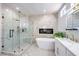 Luxurious primary bathroom with glass shower, soaking tub, dual sinks, and designer finishes at 3028 Treesdale Dr, Las Vegas, NV 89134