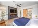 Comfortable primary bedroom featuring a fireplace, mounted TV, and a stylish ensuite bathroom at 3028 Treesdale Dr, Las Vegas, NV 89134
