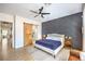 The main bedroom features a modern accent wall, ceiling fan, and sliding barn door to the bathroom at 3028 Treesdale Dr, Las Vegas, NV 89134