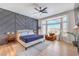 Stylish primary bedroom featuring an accent wall, a bay window, and comfortable furniture at 3028 Treesdale Dr, Las Vegas, NV 89134