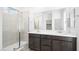 Modern bathroom featuring double vanity, quartz countertop and walk-in shower with glass enclosure and tile surround at 336 Taylor St, Henderson, NV 89015