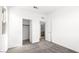 This bedroom features neutral paint, carpeted floors, an open closet, and a door to the bathroom at 336 Taylor St, Henderson, NV 89015