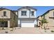 Inviting two-story home with a neutral color palette, a brick driveway, and a two-car garage at 336 Taylor St, Henderson, NV 89015