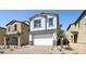 A charming two-story home featuring a two-car garage, lovely landscaping, and a beautiful paver driveway at 336 Taylor St, Henderson, NV 89015