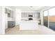 Modern kitchen with white countertops, an island, stainless appliances, gray cabinetry, and a sliding glass door at 336 Taylor St, Henderson, NV 89015