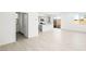 Spacious living area showcasing wood-look flooring that flows into an open kitchen with stainless appliances at 336 Taylor St, Henderson, NV 89015