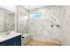 Modern bathroom with marble tile, a glass-enclosed shower, and a sleek vanity at 338 Taylor St, Henderson, NV 89015