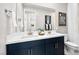 Modern bathroom features dual sinks, white countertops, and navy blue cabinets with gold hardware at 338 Taylor St, Henderson, NV 89015