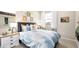 Well-lit bedroom boasts mountain views, decorative prints, and comfortable bedding at 338 Taylor St, Henderson, NV 89015