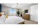 Bright bedroom featuring a modern light fixture, dresser, and a large window at 338 Taylor St, Henderson, NV 89015