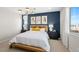 Comfortable bedroom with stylish blue accent wall, contemporary light, and natural wood furniture at 338 Taylor St, Henderson, NV 89015