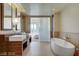Bright bathroom featuring double sink vanity with unique wood accents and modern fixtures, plus a luxurious soaking tub at 3750 S Las Vegas Blvd # 3111, Las Vegas, NV 89158