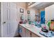 Functional bathroom featuring a single vanity, a mirror, and ample storage space, enhanced by a shower with a dolphin-themed curtain at 3950 S Sandhill Rd # 130, Las Vegas, NV 89121