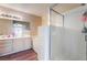 Bathroom with a white shower, white tile, a soaking tub, and wooden floors at 3950 S Sandhill Rd # 130, Las Vegas, NV 89121
